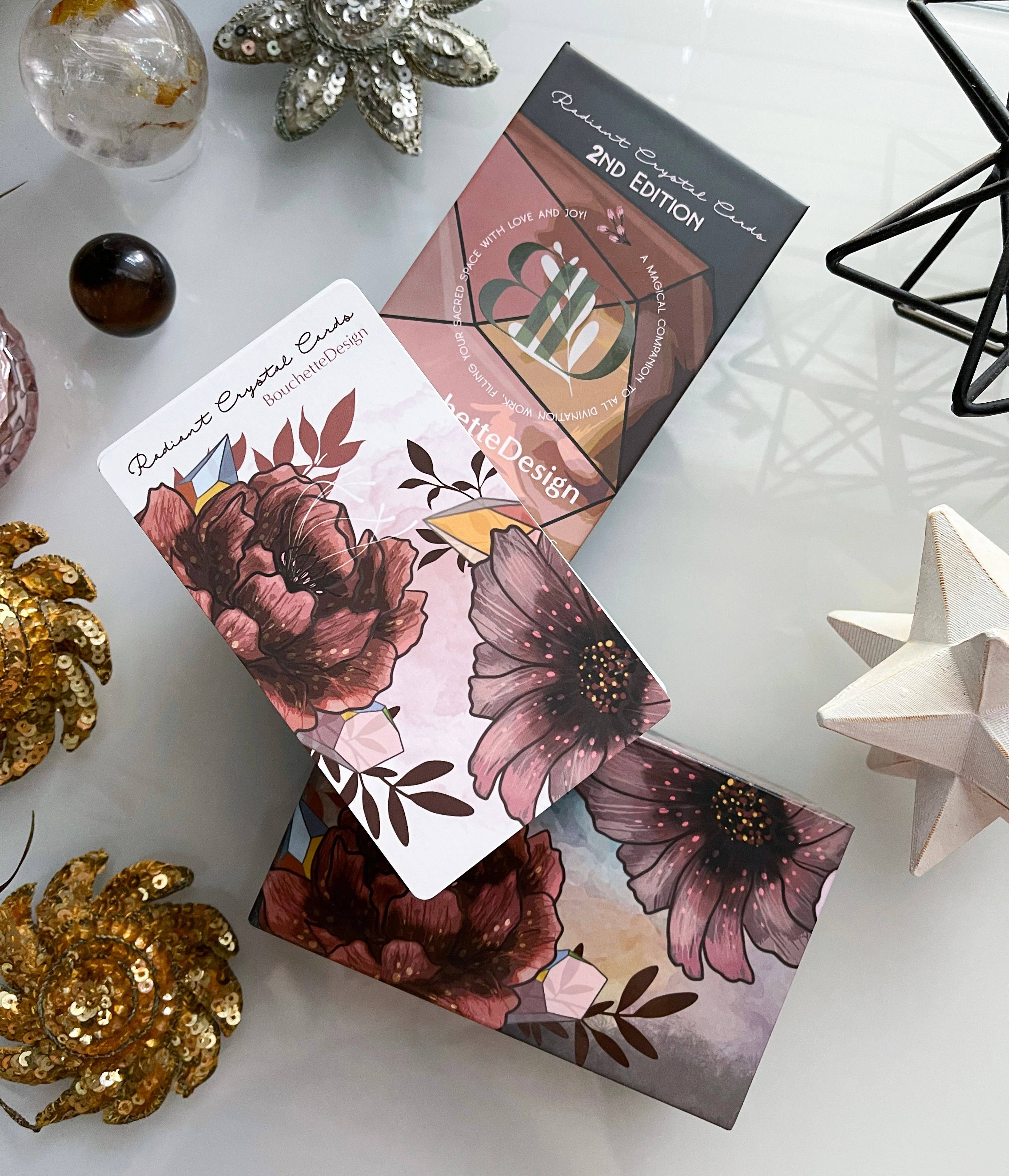Makeup palette with floral design on packaging, surrounded by decorative items on a white surface