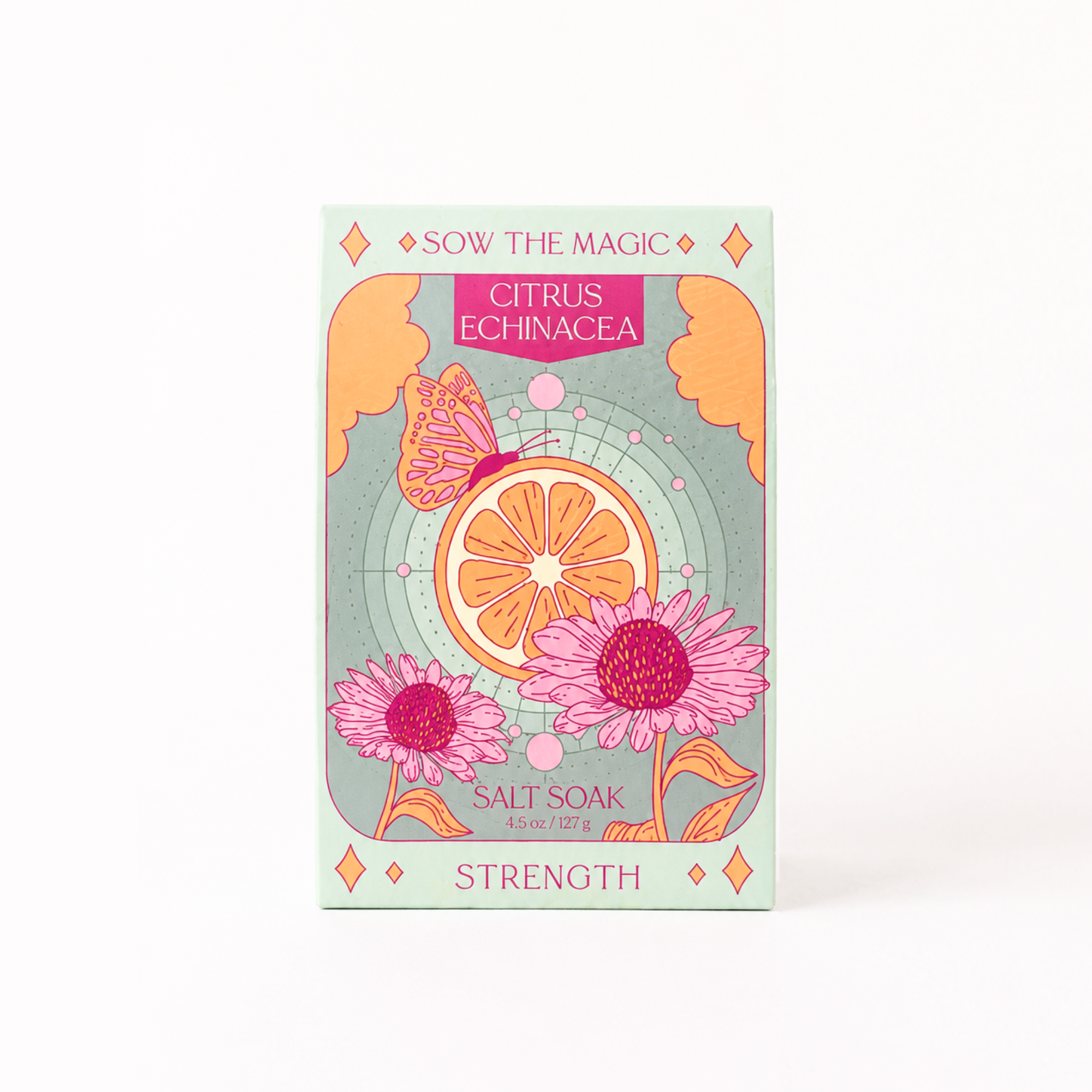 A rectangular product box for SOW THE MAGIC Salt Soak Strength, featuring a colorful illustration of a citrus slice, pink flowers, and a butterfly on a mint green background.