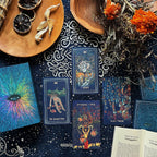 Collection of tarot cards on a dark surface with decorative elements like flowers and wood.