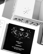 Black tarot guidebook with decorative design on a white surface