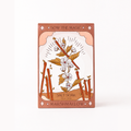 A rectangular box of Marshmallow Salt Soak featuring an Art Deco style illustration of a plant with white blossoms, brown leaves, and orange-brown branches on a cream background, with a dusty rose border. The text 'SOW THE MAGIC' is at the top and 'MARSHMALLOW SALT SOAK' is at the bottom.