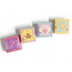 Five small boxes with colorful designs on a white background