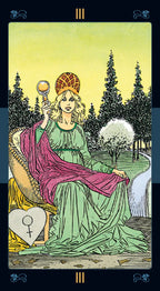 Tarot card featuring a figure in a green dress with a purple cloak, holding a mirror, in a forest setting.