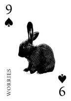 Playing card with a rabbit illustration and text '9 Worries 6' on a white background