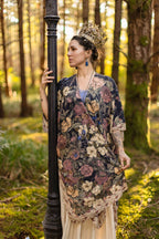 Woman in a floral dress standing in a forest