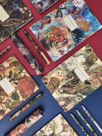 Collection of notebooks with animal illustrations on a red surface
