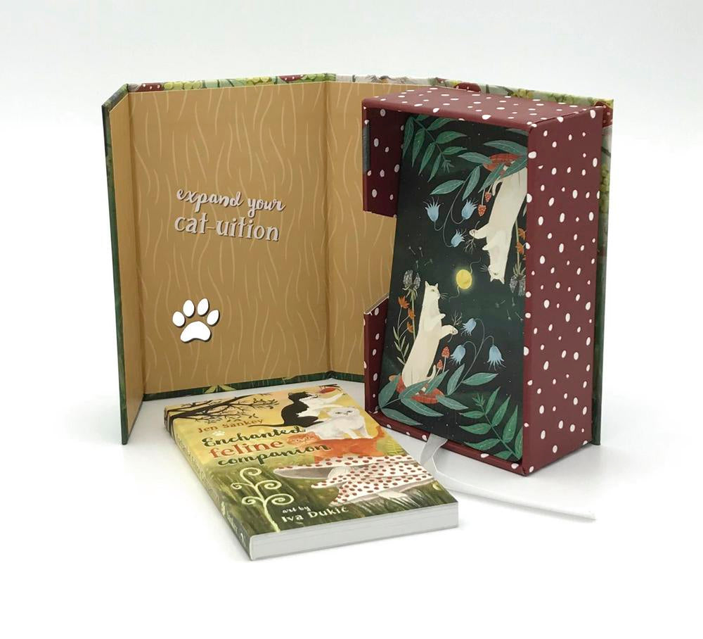 Open book with decorative cover and text, featuring a cat illustration on a white background.