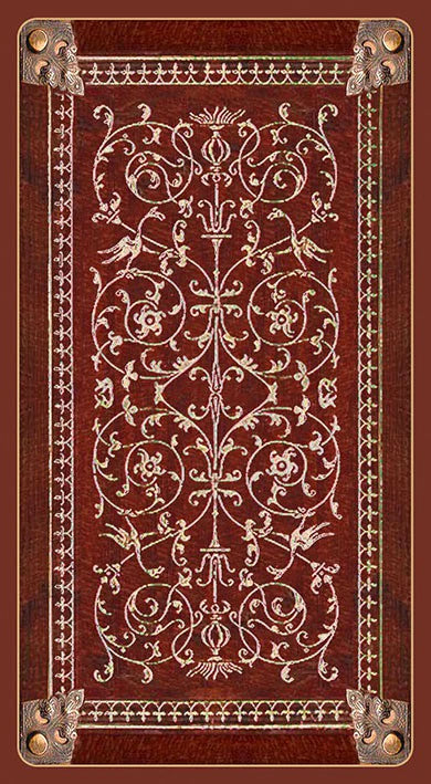 Decorative book cover with intricate patterns and metal accents on a brown background