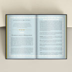 An open MORI JOURNAL spread with printed text and card guides, photographed against a light beige wall.