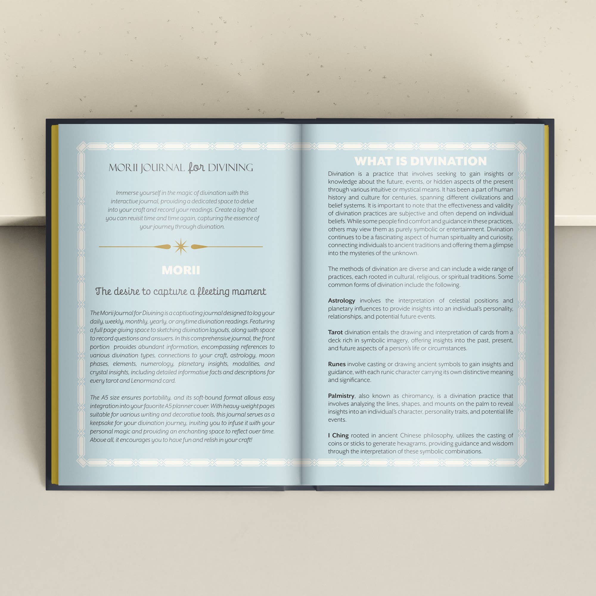 An open MORI JOURNAL spread with printed text and card guides, photographed against a light beige wall.
