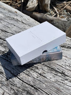 White rectangular box on a wooden surface with natural background