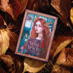 Card from 'The Wild Witch Oracle' surrounded by dried leaves