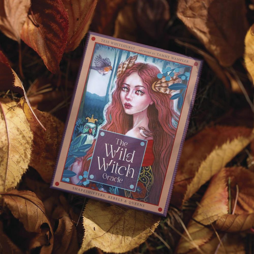 Card from 'The Wild Witch Oracle' surrounded by dried leaves