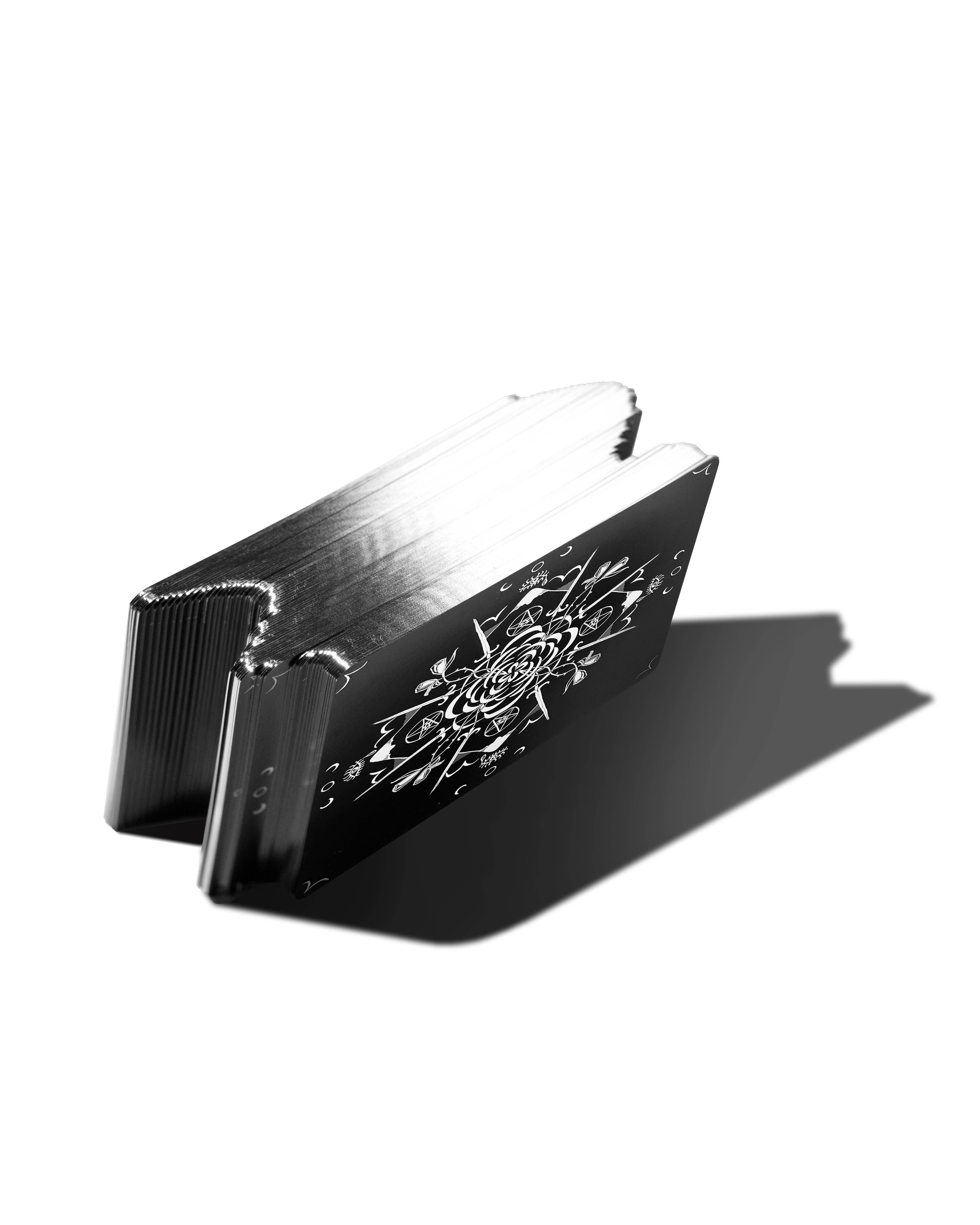Black and silver wallet with intricate design on a white background