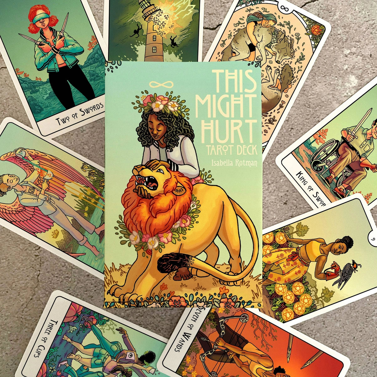Collection of tarot cards with colorful artwork on a textured surface