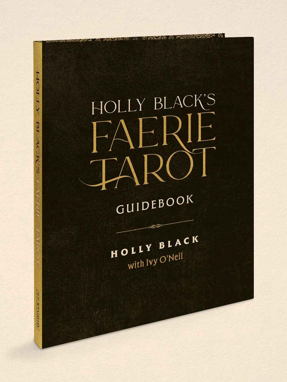 Holly Black's Faerie Tarot Guidebook, featuring a textured black cover with elegant gold lettering, shown at a three-quarter angle on a light beige background.