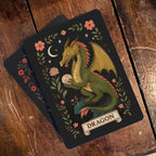 Card with a dragon illustration on a wooden surface