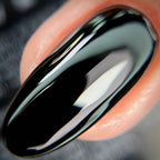Black ceramic ring on a person's finger with a blurred background