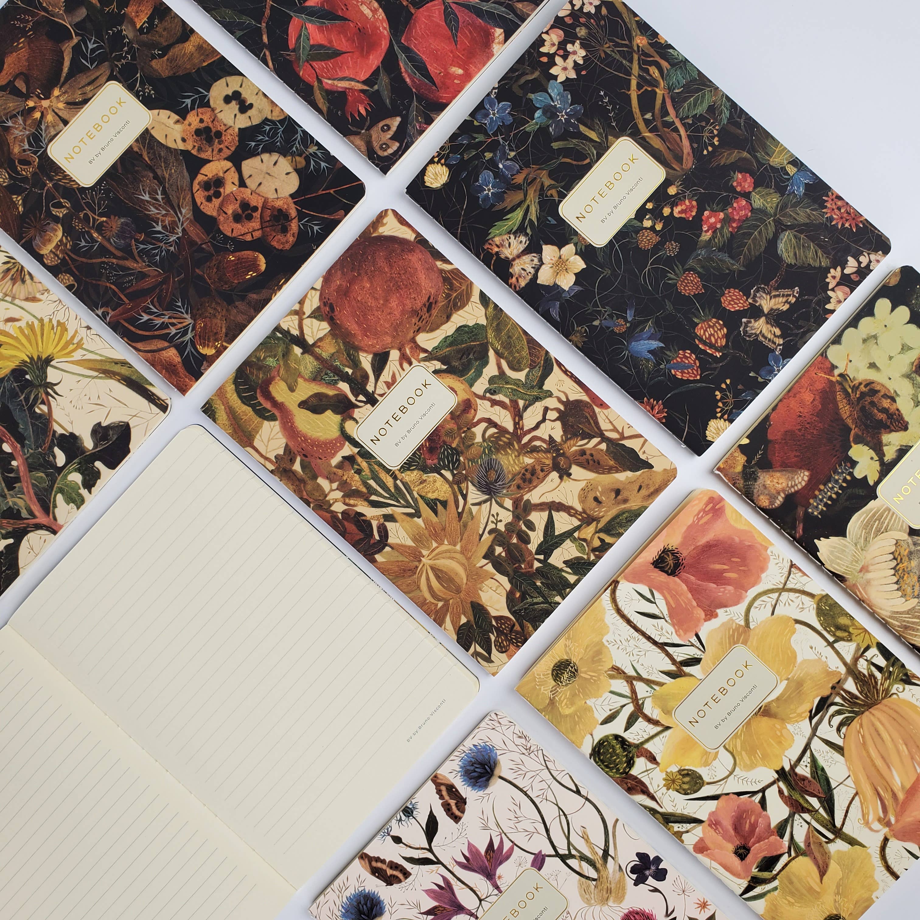 Collection of notebooks with floral designs and visible brand name.