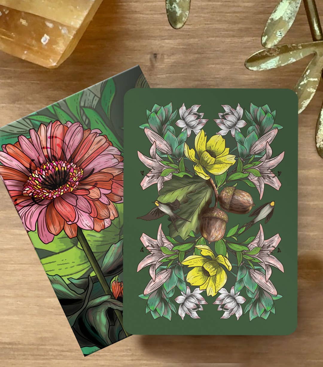 Two floral cards on a wooden surface with decorative elements.