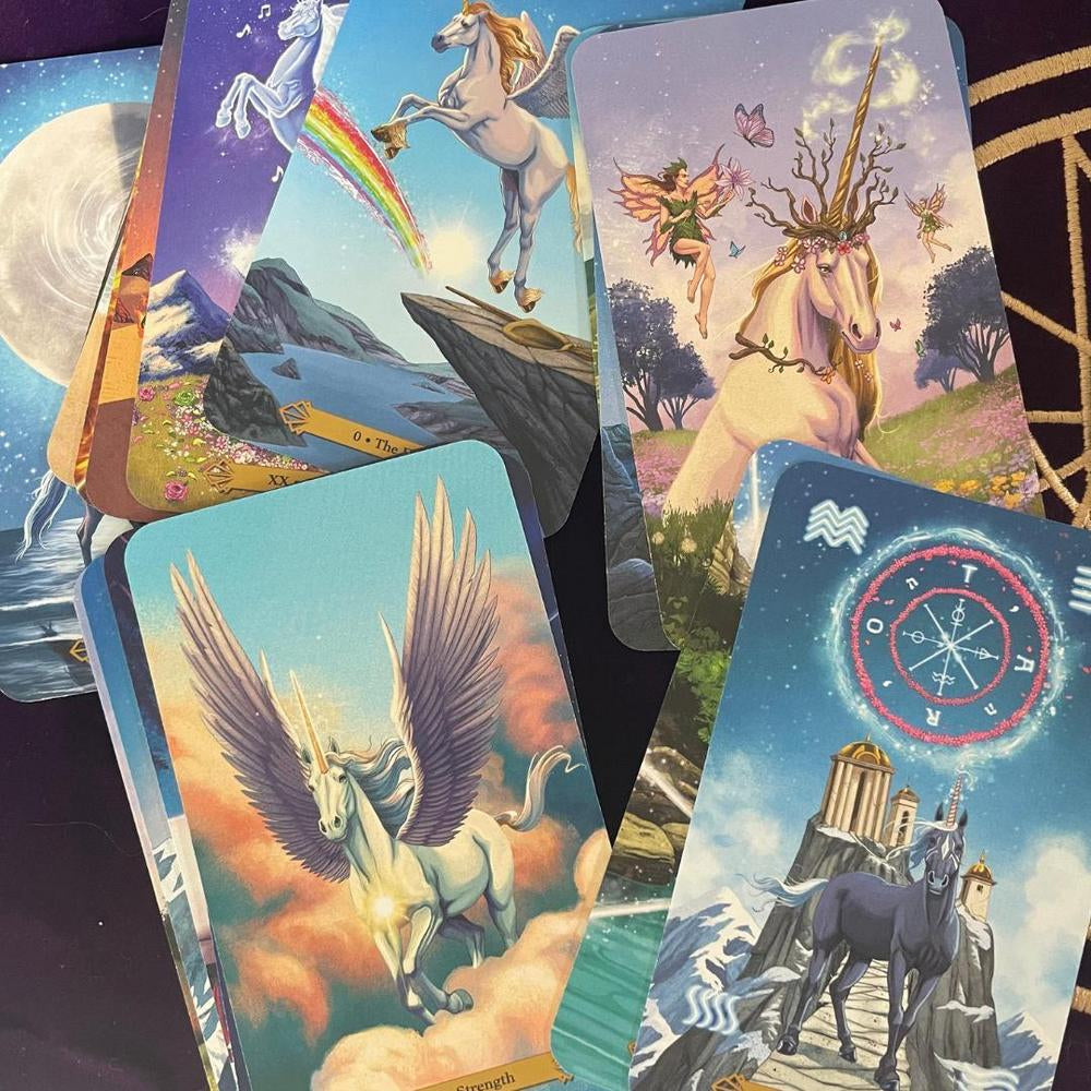 Collection of tarot cards featuring mythical creatures and landscapes