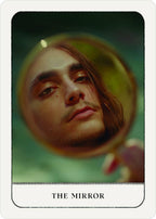 Card titled 'The Mirror' with a reflection of a person's face in a circular mirror.
