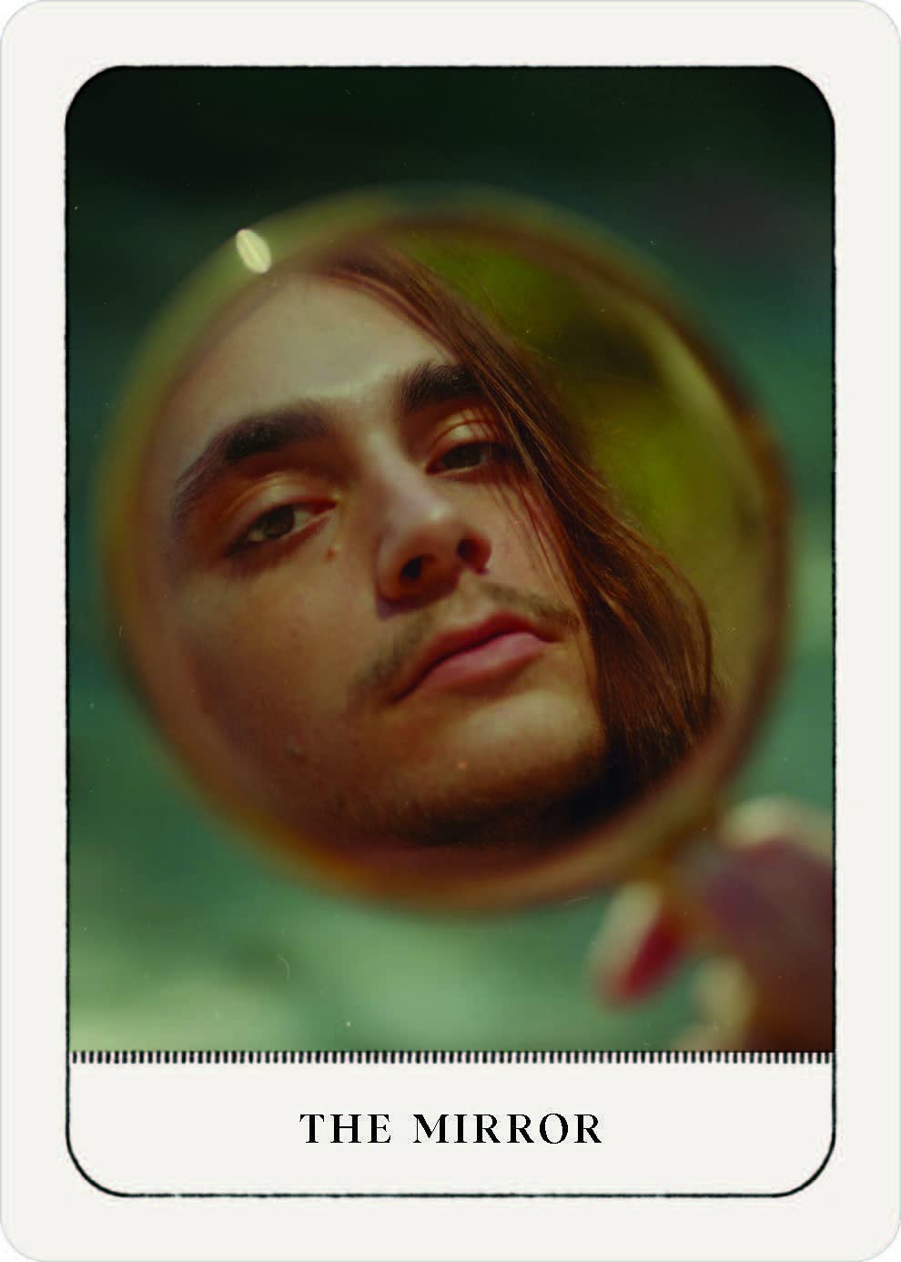 Card titled 'The Mirror' with a reflection of a person's face in a circular mirror.