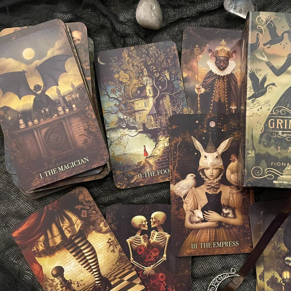 Collection of tarot cards with intricate designs on a dark textured surface.