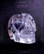 Clear crystal skull on a dark background with 'AMAR' branding.