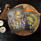 Two oracle cards from 'A Witch's Ally Oracle' on a dark surface with a broom and other items.