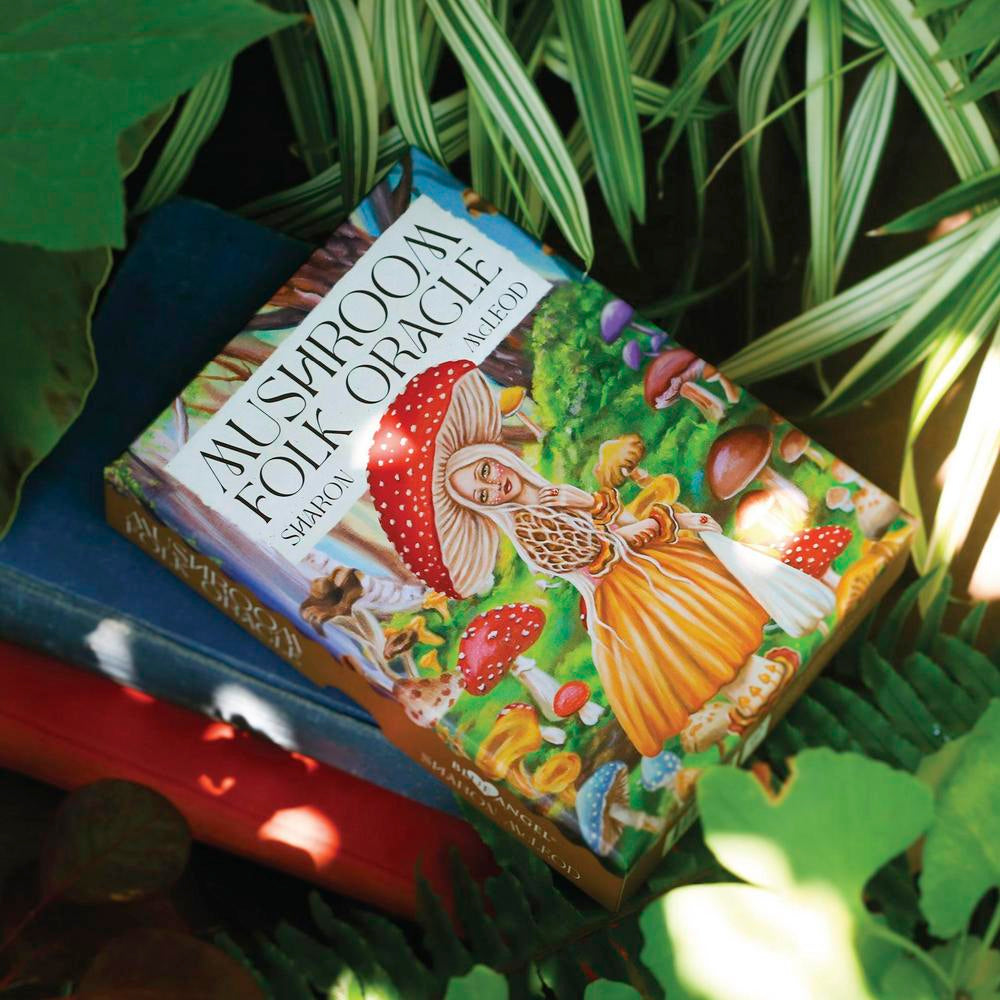 Card deck titled 'Alviriroom Folk Oracle' surrounded by green leaves