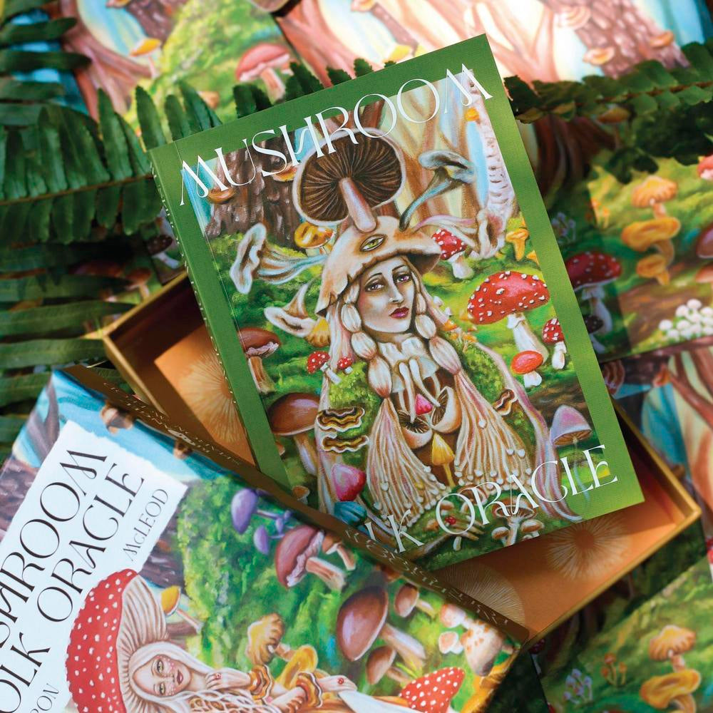 Mushroom Oracle card deck with colorful illustrations on a forest-themed background