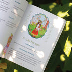 Open book with a page titled 'The Forager' surrounded by green leaves