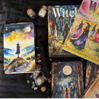 Collection of tarot cards and mystical items on a dark surface