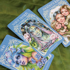 Three tarot cards featuring artistic illustrations of characters with floral elements on a green leaf background.