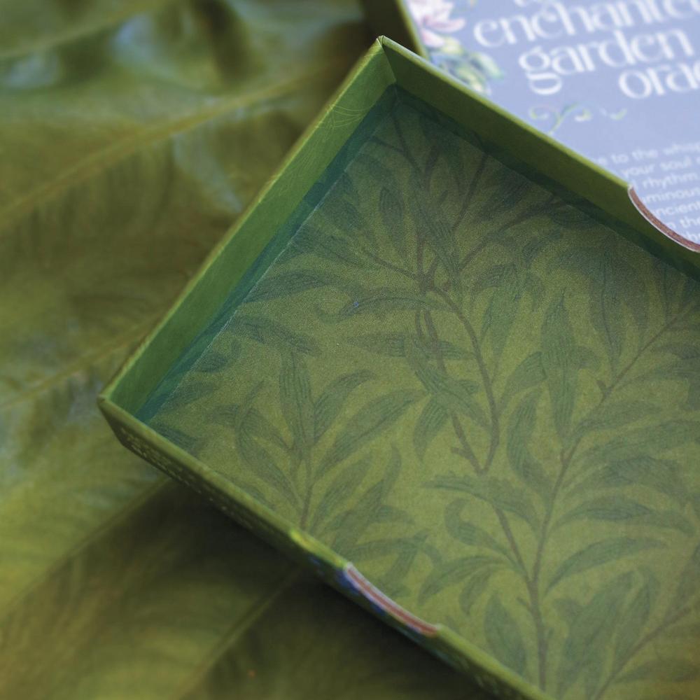 Green box with leaf pattern on a green leafy background