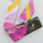 Two fabric neckties with colorful patterns on a light gray background