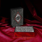Decorative boxes with intricate designs on a red fabric background