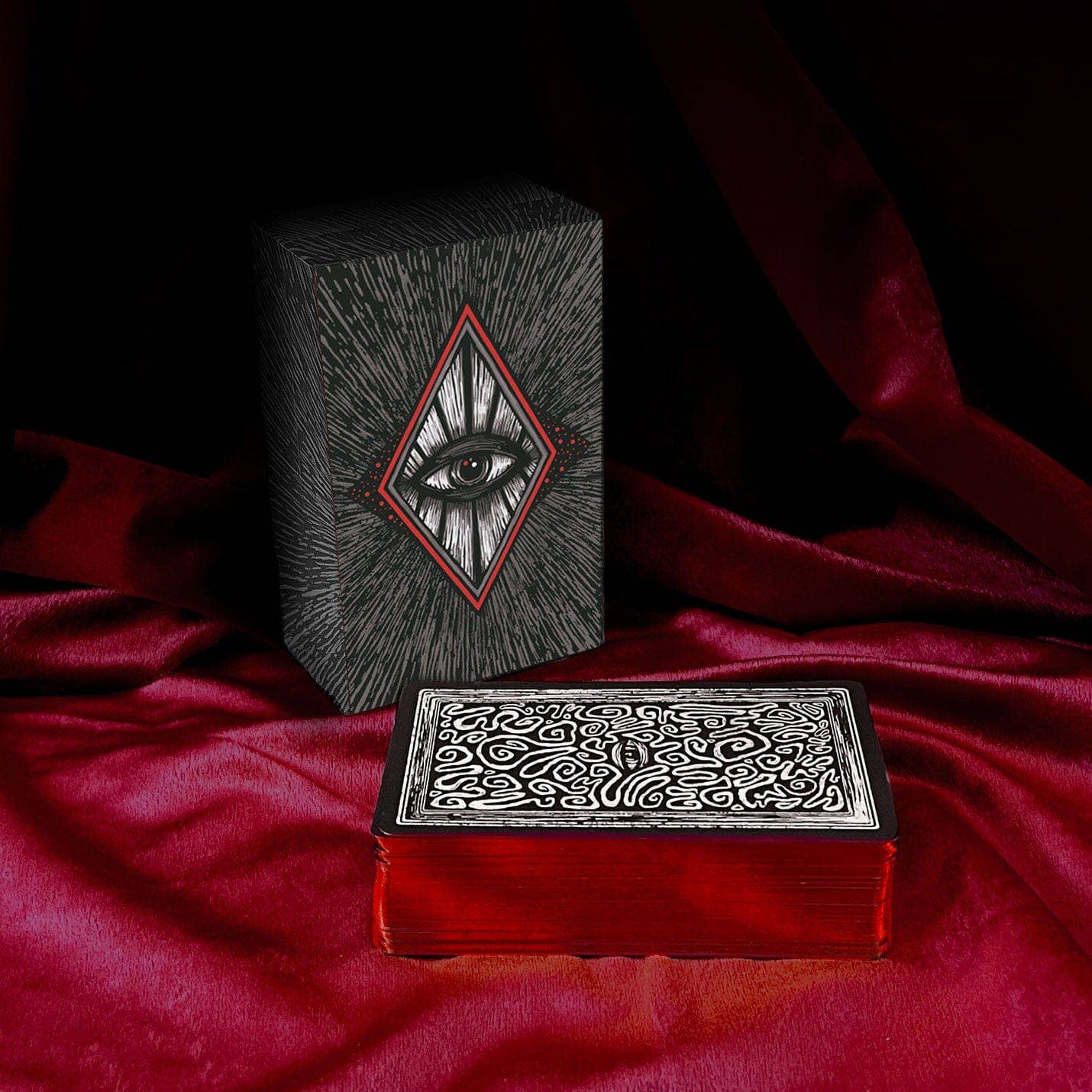 Decorative boxes with intricate designs on a red fabric background