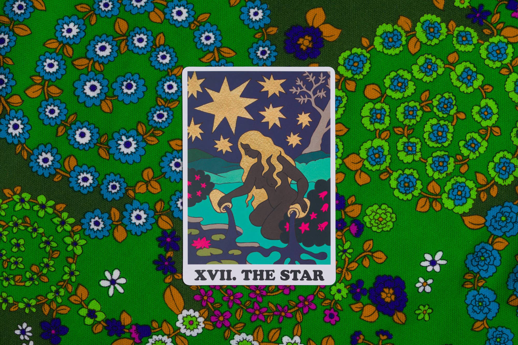 Tarot card 'The Star' on a colorful floral background