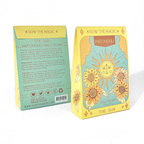 Two packaging boxes for 'Sow the Magic' Patchouli Salt Soak with sun and flower designs.
