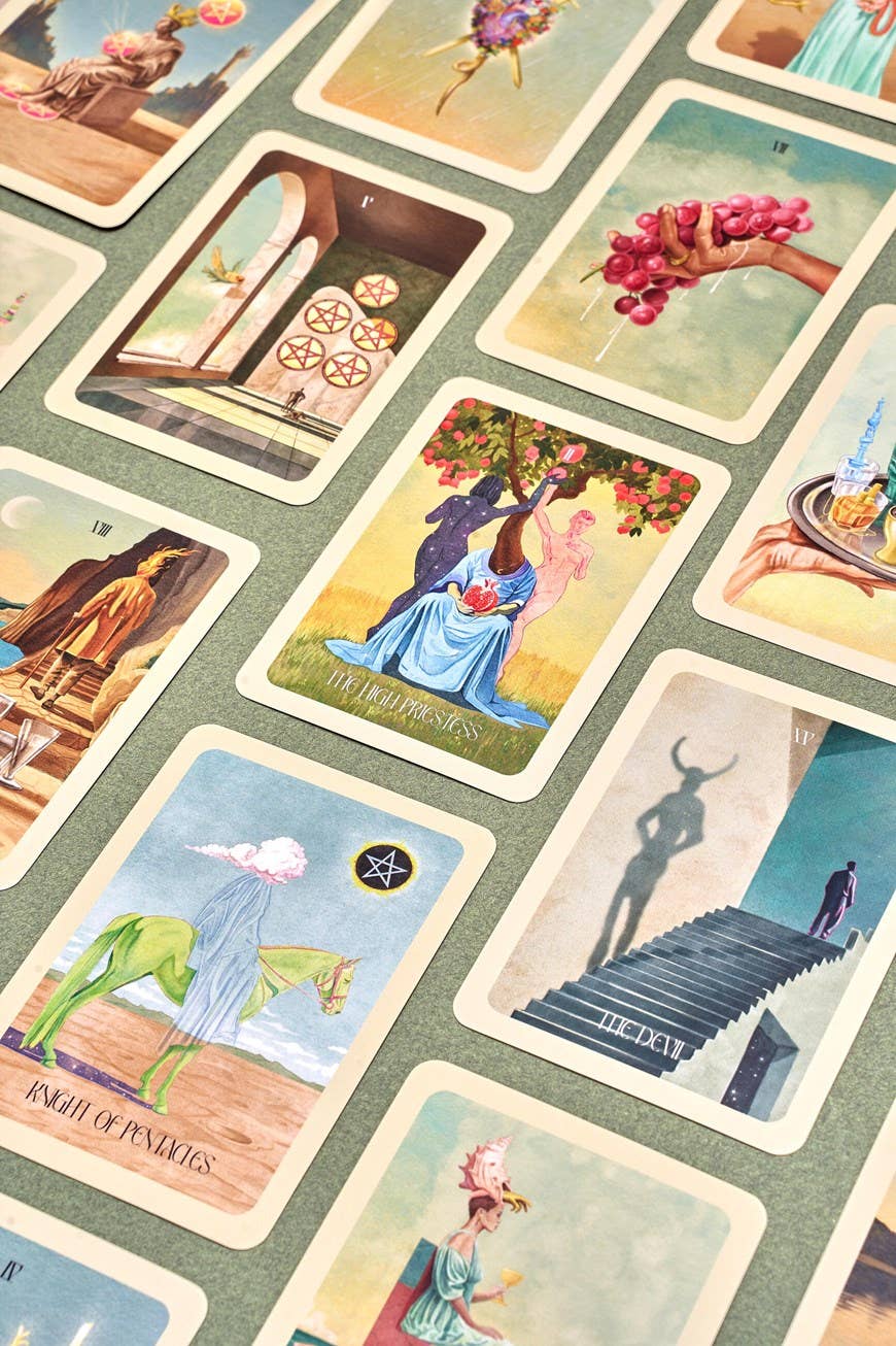 Collection of tarot cards with various illustrations on a textured surface.