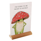 Card with a frog wearing a red mushroom hat and text on a white background