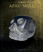Decorative Aztec skull with intricate carvings on a dark background