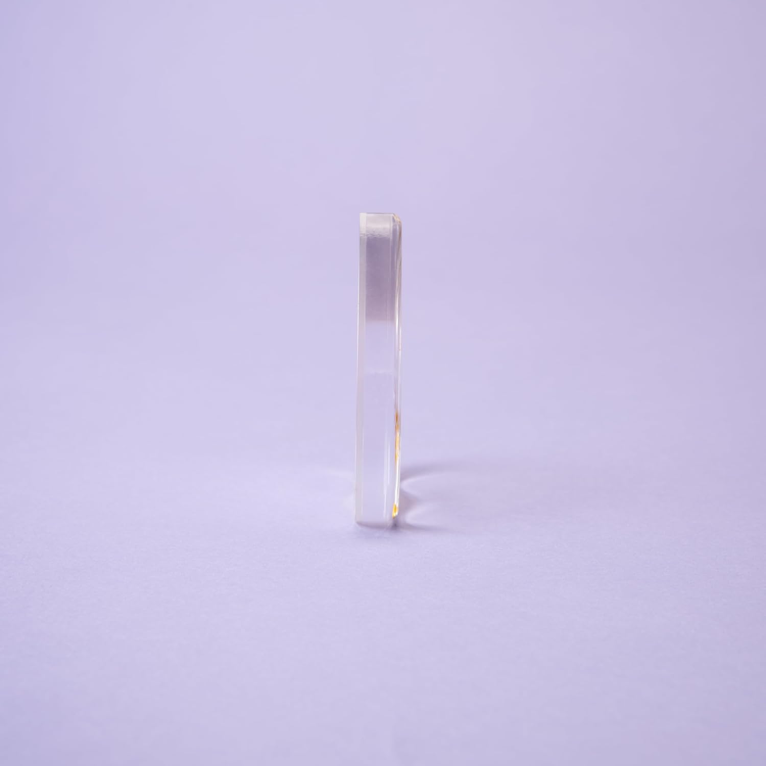 Rectangular glass object on a light purple background