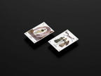 Two playing cards with illustrations on a black background