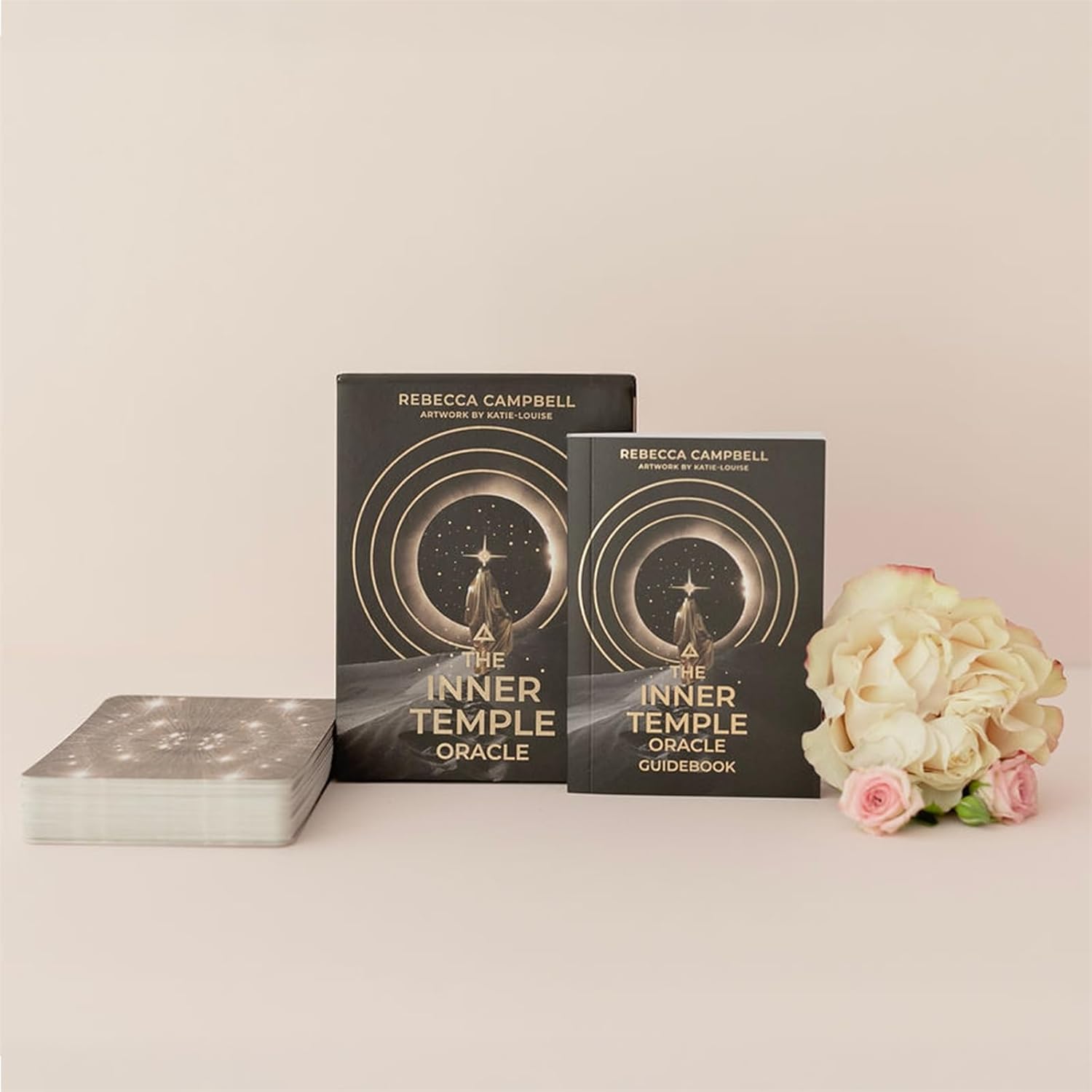 Two books titled 'The Inner Temple Oracle' by Rebecca Campbell on a light surface with flowers.