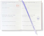 Meditation journal with pen on a white background