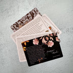 Set of cards with floral designs and text on a textured surface