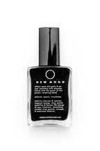 New Moon black crystal healing resin in a clear glass bottle with a black cap, on a white background.